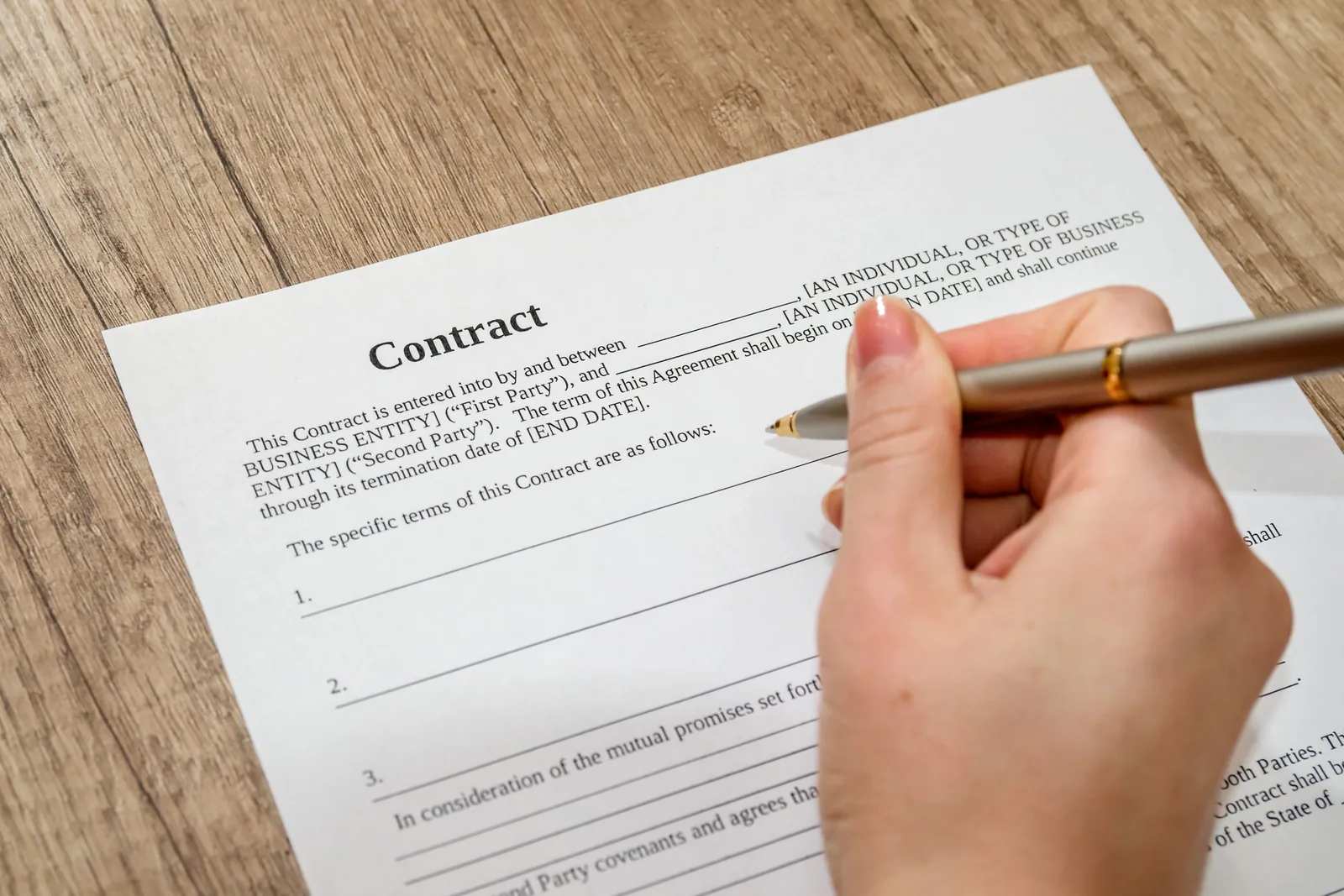 Hand ondertekent een document met een pen.
